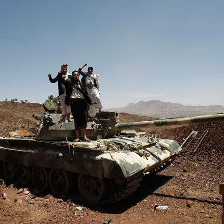 In this photo taken on Monday, Sept. 22, 2014, Hawthi Shiite rebels stand on a tank at the headquarters of the army's 1st Armored Division, in Sanaa, Yemen. (AP Photo/Hani Mohammed)