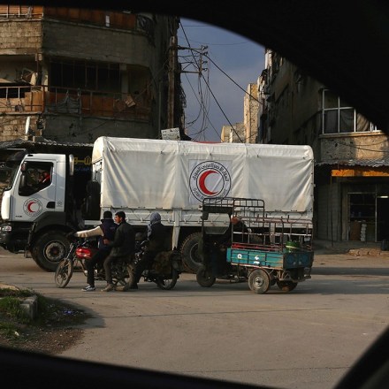 A Syrian Red Crescent truck part of a convoy carrying humanitarian aid is seen in Kafr Batna, on the outskirts of Damascus on February 23, 2016, during an operation in cooperation with the UN to deliver aid to thousands of besieged Syrians.