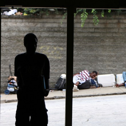 In this Aug. 7, 2017 photo, a person walks into the the Peachtree-Pine homeless shelter, in Atlanta. For decades, as many as 1,000 people with nowhere else to turn could come off the street at Peachtree and Pine, no questions asked. (AP Photo/Robert Ray)