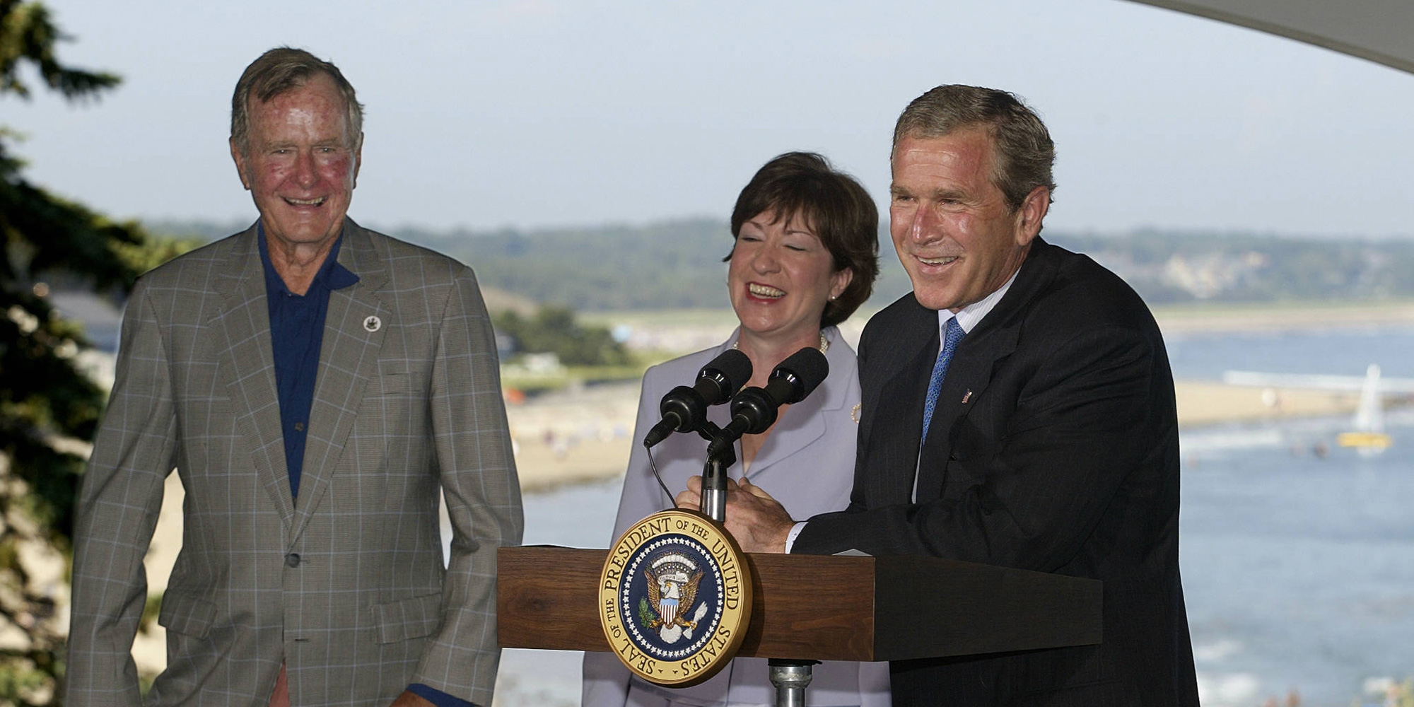 PROUTS NECK, UNITED STATES:  US President George W. Bush (R) and his father former president George Bush (L) attend a fundraiser for US Senator Susan Collins (C), R-ME, in Prouts Neck, Maine, 03 August 2002.  President Bush is vacationing at the Bush family home in Kennebunkport, Maine until 05 August.          AFP PHOTO  Luke FRAZZA (Photo credit should read LUKE FRAZZA/AFP/Getty Images)