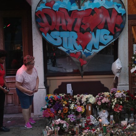 DAYTON, OHIO - AUGUST 06: People look over a memorial to those killed in Sunday morning's mass shooting while the businesses along E. 5th Street in the Oregon District try to return to normal on August 06, 2019 in Dayton, Ohio.  Nine people were killed and another 27 injured when a gunman identified as 24-year-old Connor Betts opened fire with a AR-15 style rifle in the popular entertainment district. Betts was subsequently shot and killed by police. The shooting happened less than 24 hours after a gunman in Texas opened fire at a shopping mall killing 22 people.  (Photo by Scott Olson/Getty Images)