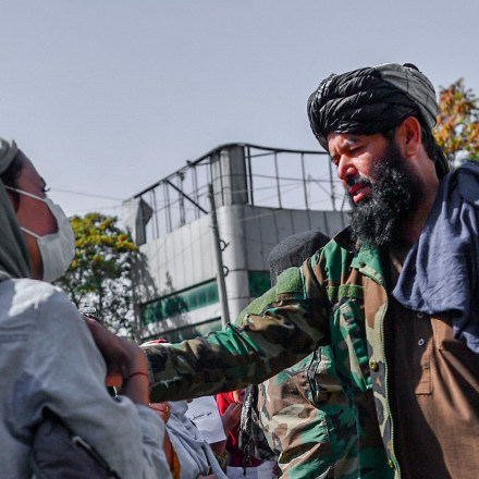 Taliban members stop women protesting for women's rights in Kabul on October 21, 2021.