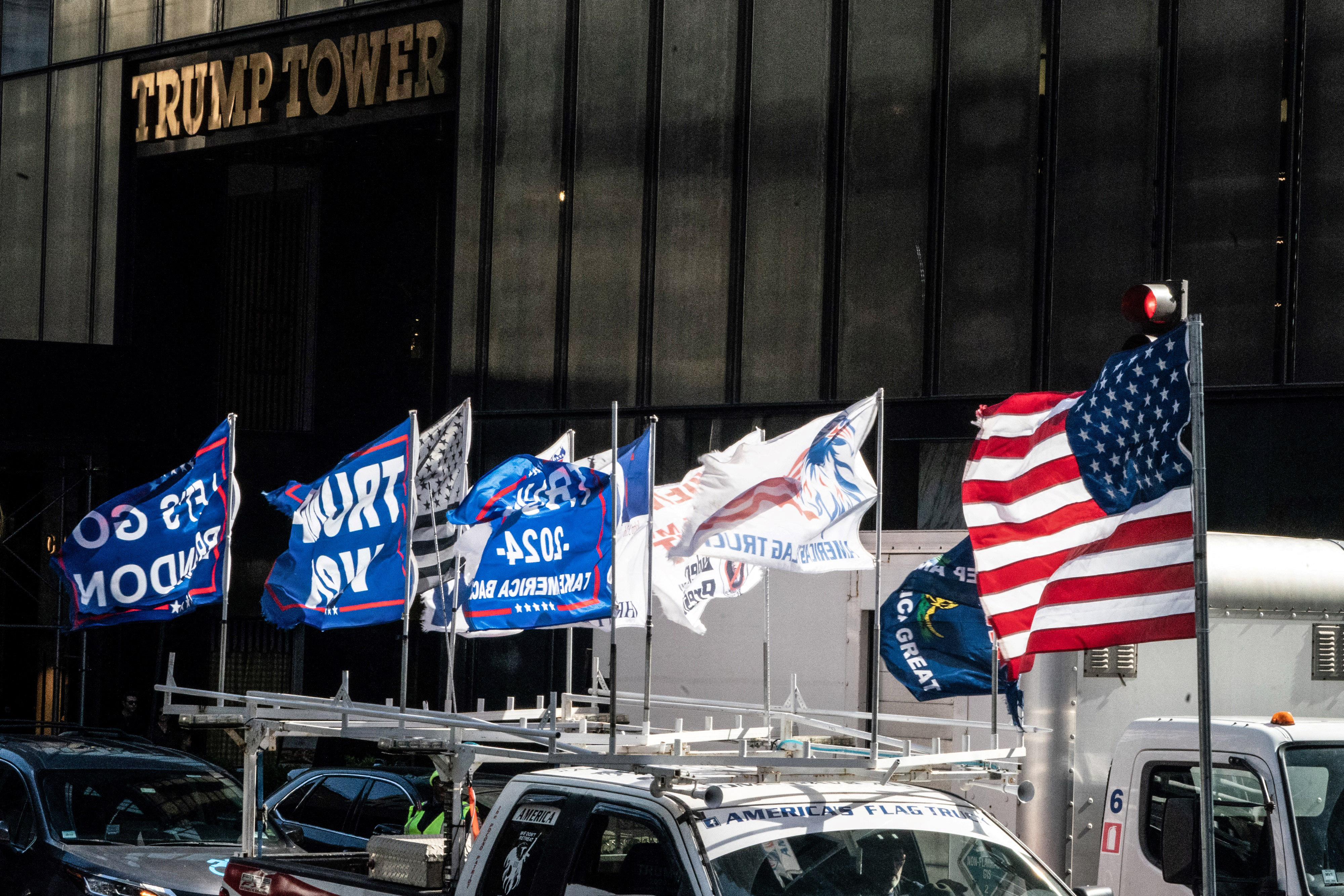 Supporters of former US president Donald Trump drive down Fifth Avenue before Trump leaves from Trump Tower for his arraignment in lower Manhattan on April 4, 2023 in New York. - The 76-year-old Republican, the first US president ever to be criminally indicted, will be formally charged  over hush money paid to a porn star during the 2016 election campaign (Photo by Bryan R. Smith / AFP) (Photo by BRYAN R. SMITH/AFP via Getty Images)