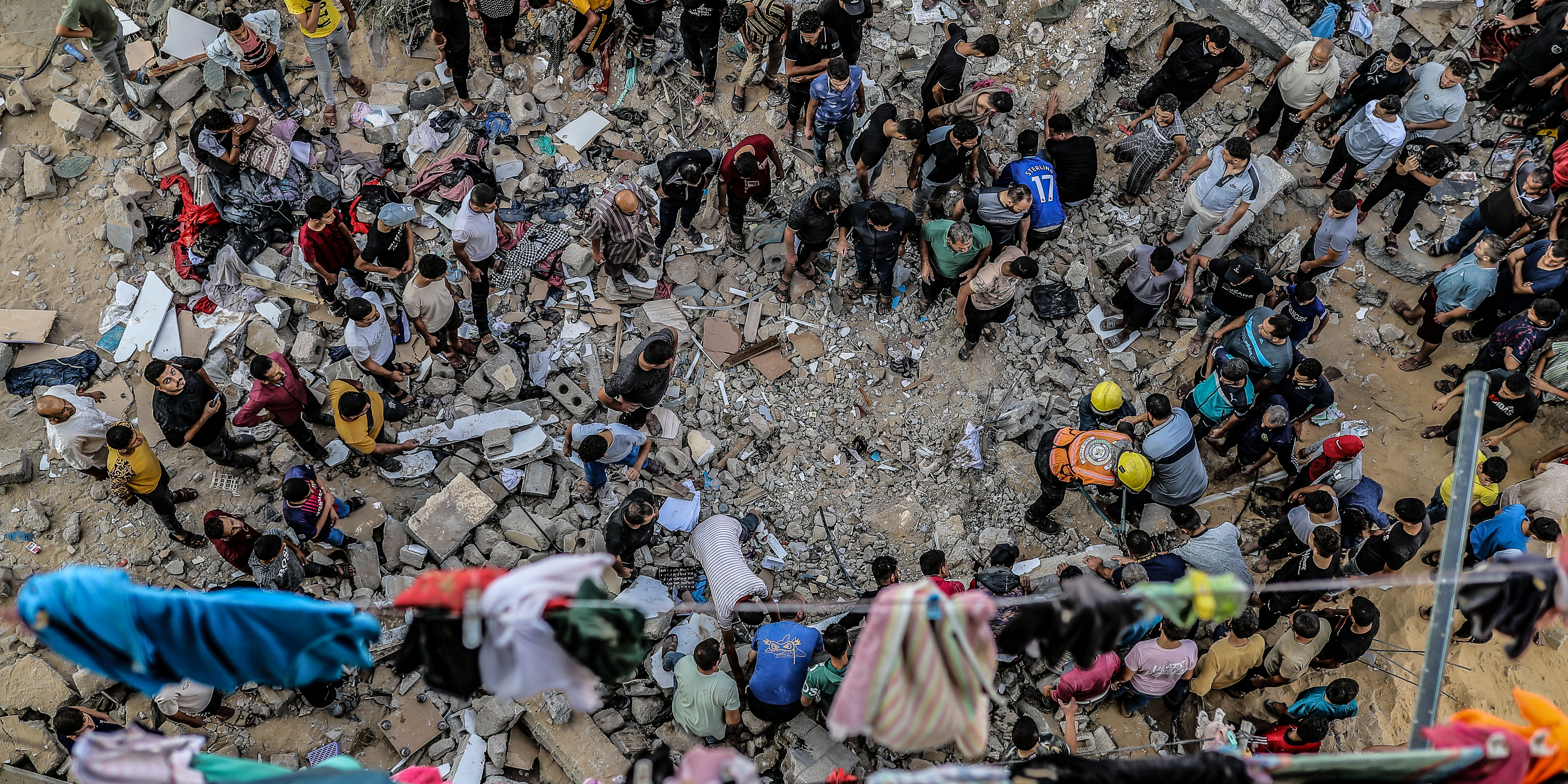 KHAN YUNIS, GAZA - OCTOBER 16: Civil defense teams and locals rush to rescue people from rubble of destroyed house of a Palestinian family hit by an Israeli airstrike in Khan Yunis, Gaza on October 16, 2023. (Photo by Belal Khaled/Anadolu via Getty Images)