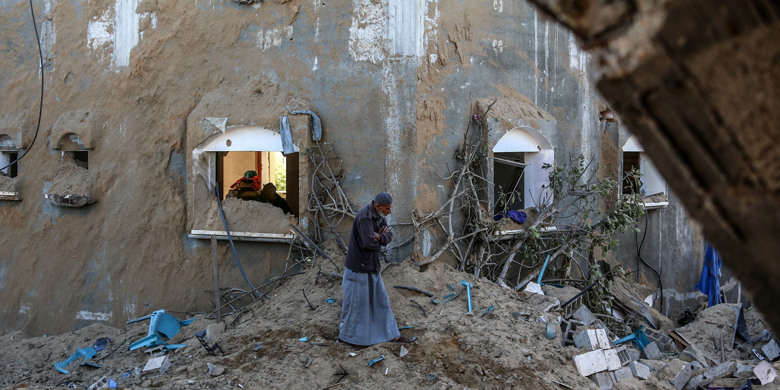 KHAN YUNIS, GAZA - OCTOBER 25: A view of destroyed buildings at the al-Manera neighbourhood as the Palestinians observe the damaged area after the Israeli airstrikes in Khan Yunis, Gaza on October 25, 2024. (Photo by Abed Rahim Khatib/Anadolu via Getty Images)