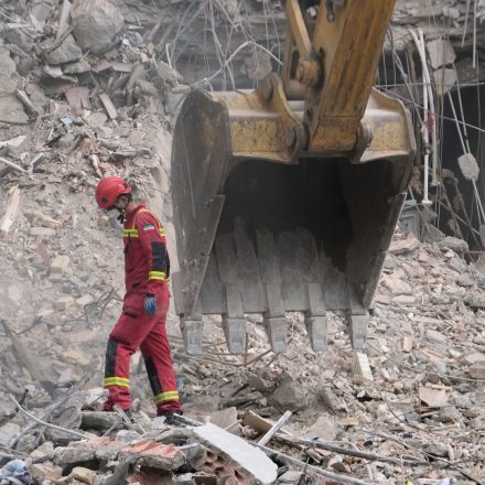 Iranian Red Crescent emergency workers use a bulldozer to clear rubble from a residential building that was hit in an earlier U.S.-Israeli strike in Tehran, Iran, Monday, March 23, 2026. (AP Photo/Vahid Salemi)