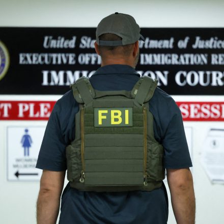 FBI OFFICER waits in a hallway outside of a courtroom at New York-Federal Plaza Immigration Court inside the Jacob K. Javitz Federal Building in New York City on June 11, 2025. The New York-Federal Plaza Immigration Court falls under the jurisdiction of the Executive Office for Immigration Review, a sub-agency of the US Department of Justice. US President Donald Trump has made deporting undocumented immigrants a key priority for his second term, after successfully campaigning against an alleged "invasion" by criminals. (Photo by CHARLY TRIBALLEAU / AFP) (Photo by CHARLY TRIBALLEAU/AFP via Getty Images)