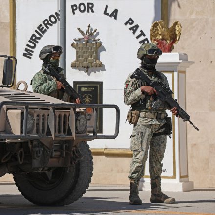 Soldiers from the Mexican Army guard the facilities of the Military Garrison in Ciudad Juarez, Chihuahua state, Mexico, on February 23, 2026. Mexico has deployed 10,000 troops to quell clashes sparked by the killing of the country's most wanted drug lord, which have left dozens dead, officials said on February 23. Nemesio "El Mencho" Oseguera, leader of the Jalisco New Generation Cartel (CJNG), was wounded on February 22 in a shootout with soldiers in the town of Tapalpa in Jalisco state and died while being flown to Mexico City, the army said. (Photo by Herika Martinez / AFP via Getty Images)