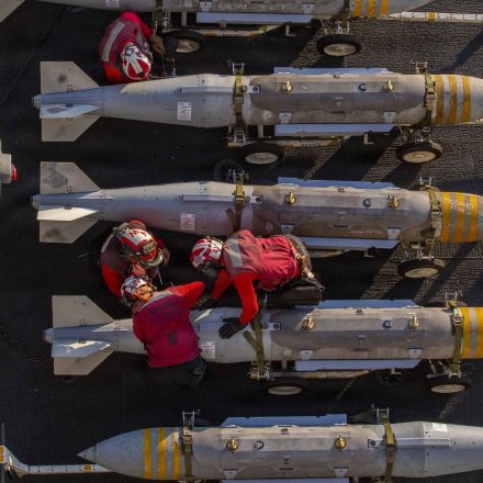 U.S. sailors prepare to stage ordnance on the flight deck of Nimitz-class aircraft carrier USS Abraham Lincoln on Feb. 28, 2026 at sea.