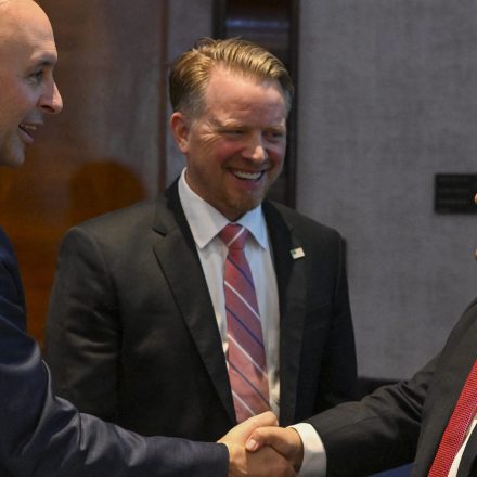 The Inter-American Commission on Human Rights Commissioner Edgar Stuardo Ralon, right, shakes hands with the U.S. Department of State Office of the Legal Adviser, Carl Anderson, left, alongside James Bischoff after a public hearing in Guatemala City on March 13, 2026.