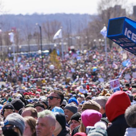 A person holds up a whistle-shaped sign reading "ICE out" outside the Minnesota State Capitol during the "No Kings" national day of protest in Saint Paul, Minnesota, on March 28, 2026. Nationwide protests against US President Donald Trump are expected Saturday as millions of people vent fury over what they see as his authoritarian bent and other forms of cruel, law-trampling governance. It is the third time in less than a year that Americans will take to the streets as part of a grassroots movement called "No Kings," the most vocal and visual conduit for opposition to Trump since he began his second term in January 2025. (Photo by Kerem YUCEL / AFP via Getty Images)