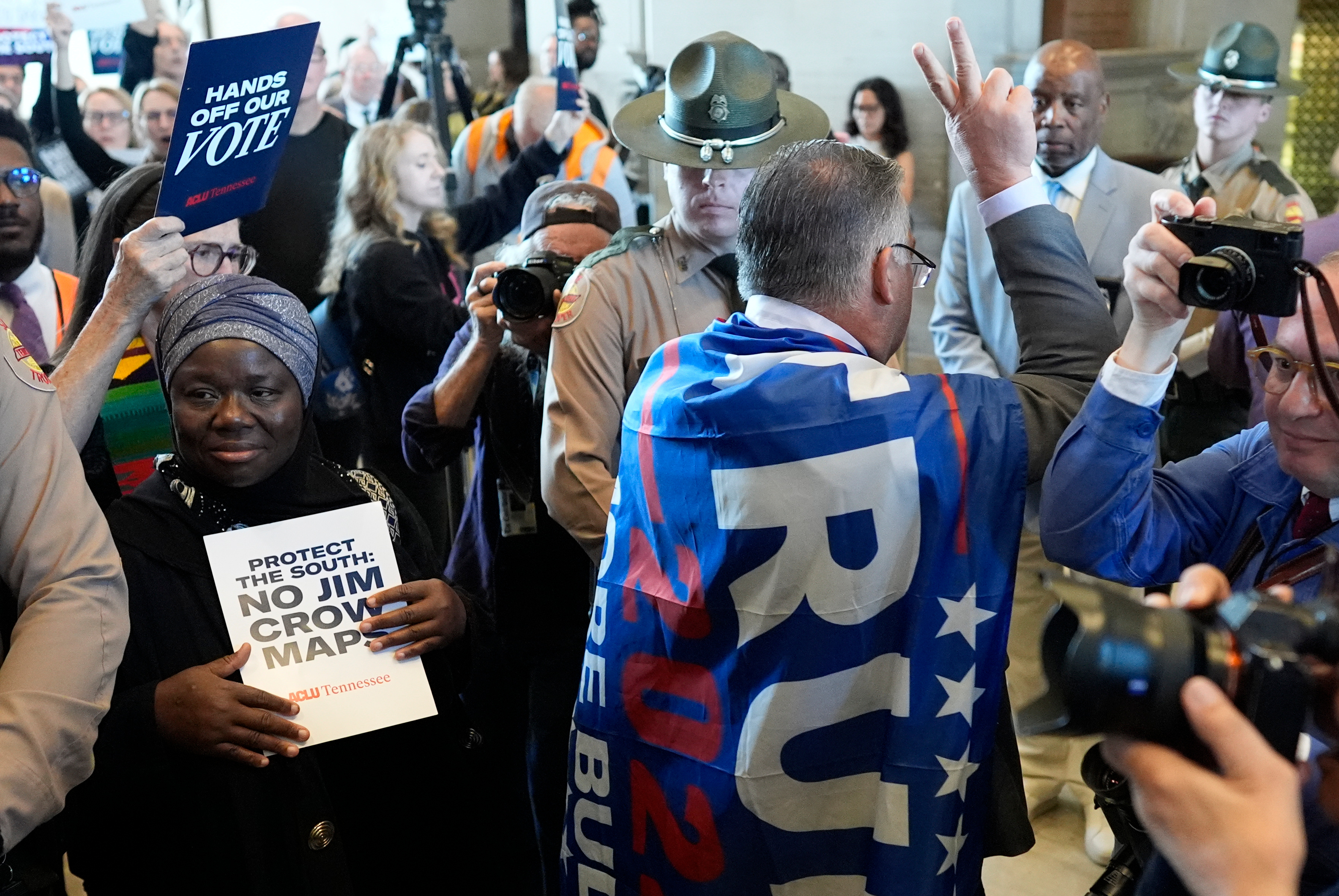 Rep. Todd Warner, R-Chapel Hill, arrives to the House chamber wearing a Trump flag for a special session of the state legislature to redraw U.S. Congressional voting maps Thursday, May 7, 2026, in Nashville, Tenn. (AP Photo/George Walker IV)