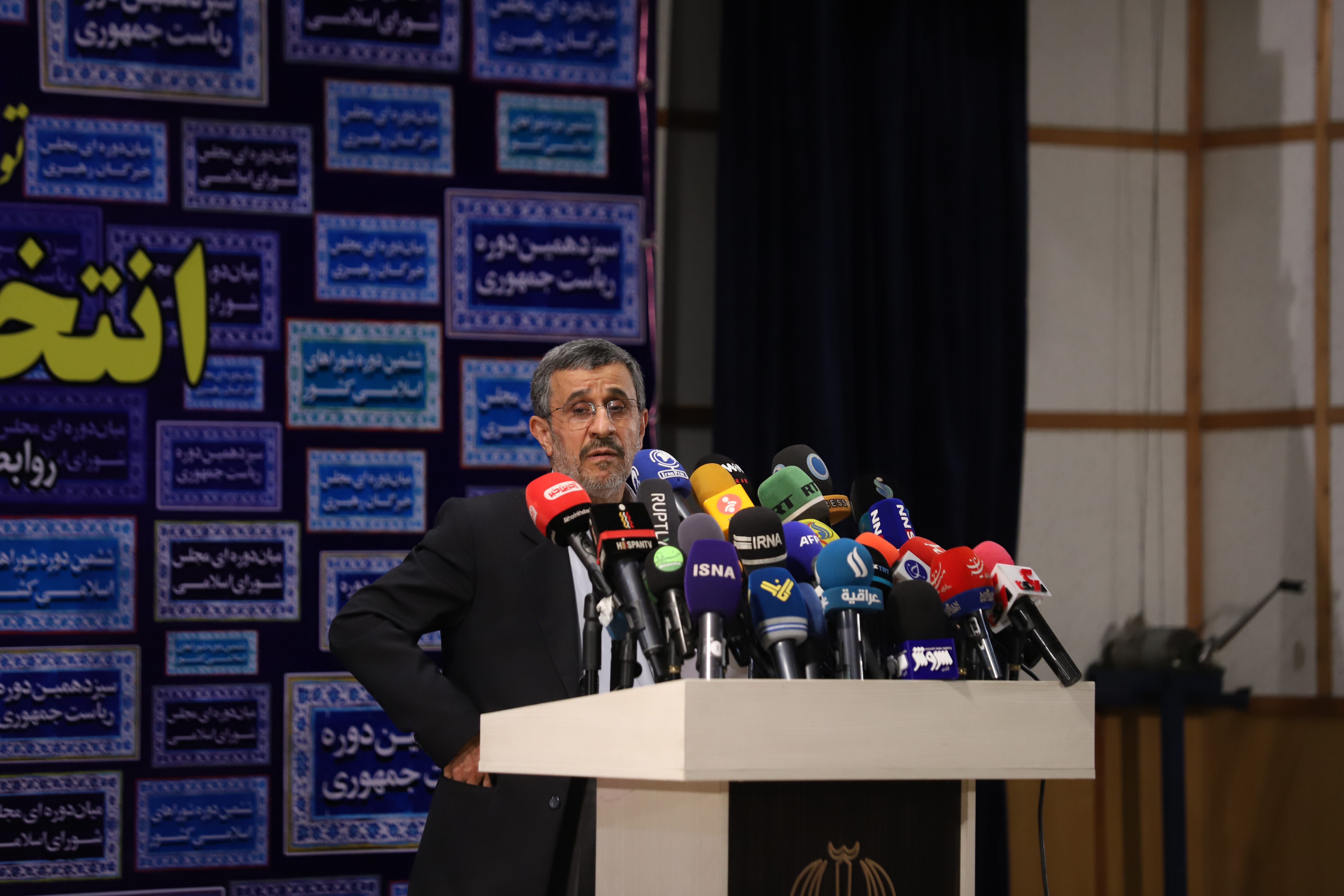 TEHRAN, IRAN - MAY 12: Iran's former president Mahmoud Ahmadinejad reads his statement while attending a press center after registering as a candidate for June 18, presidential elections, in the Iranian Interior Ministry building on May 12, 2021 in Tehran, Iran. (Photo by Majid Saeedi/Getty Images)