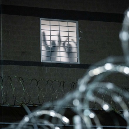 NEWARK, NEW JERSEY - MAY 26: Detainees stand by a window inside the federal immigration center at Delaney Hall in Newark, where ICE is housing detained immigrants on May 26, 2026 in Newark, New Jersey. The protests, which have become tense over the holiday weekend, come amid reports of an ongoing hunger strike by detainees. (Photo by Adam Gray/Getty Images)