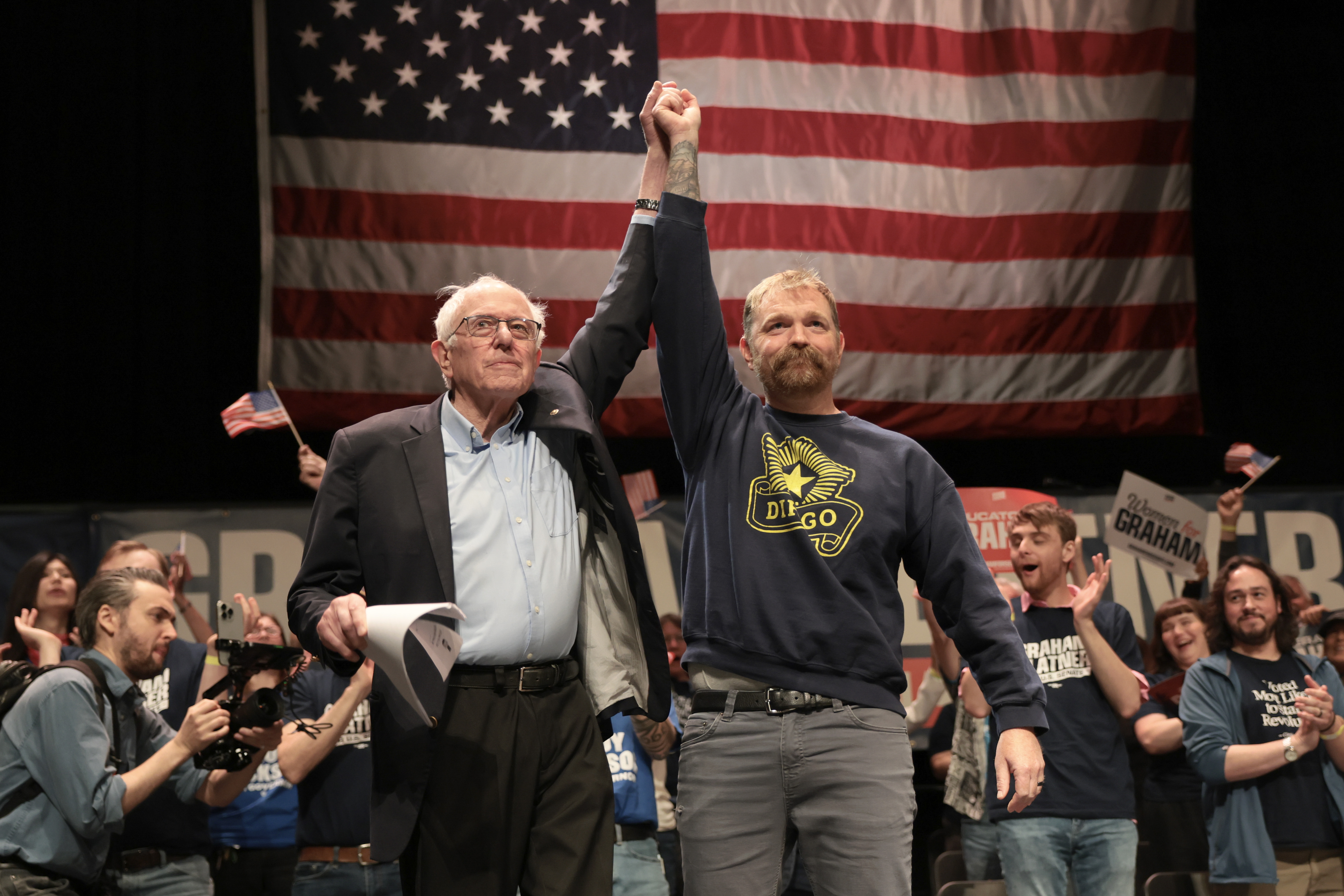 ORONO, MAINE - MAY 24: Sen. Bernie Sanders (I-VT) and Democratic U.S. Senate candidate Graham Platner stand together during a “Fighting Oligarchy” tour stop at the Collins Center for the Arts on the University of Maine campus on May 24, 2026 in Orono, Maine. Platner is the presumptive Democratic nominee and will face incumbent Sen. Susan Collins (R-ME) for Maine's U.S. Senate seat in the general election.  (Photo by Joe Raedle/Getty Images)