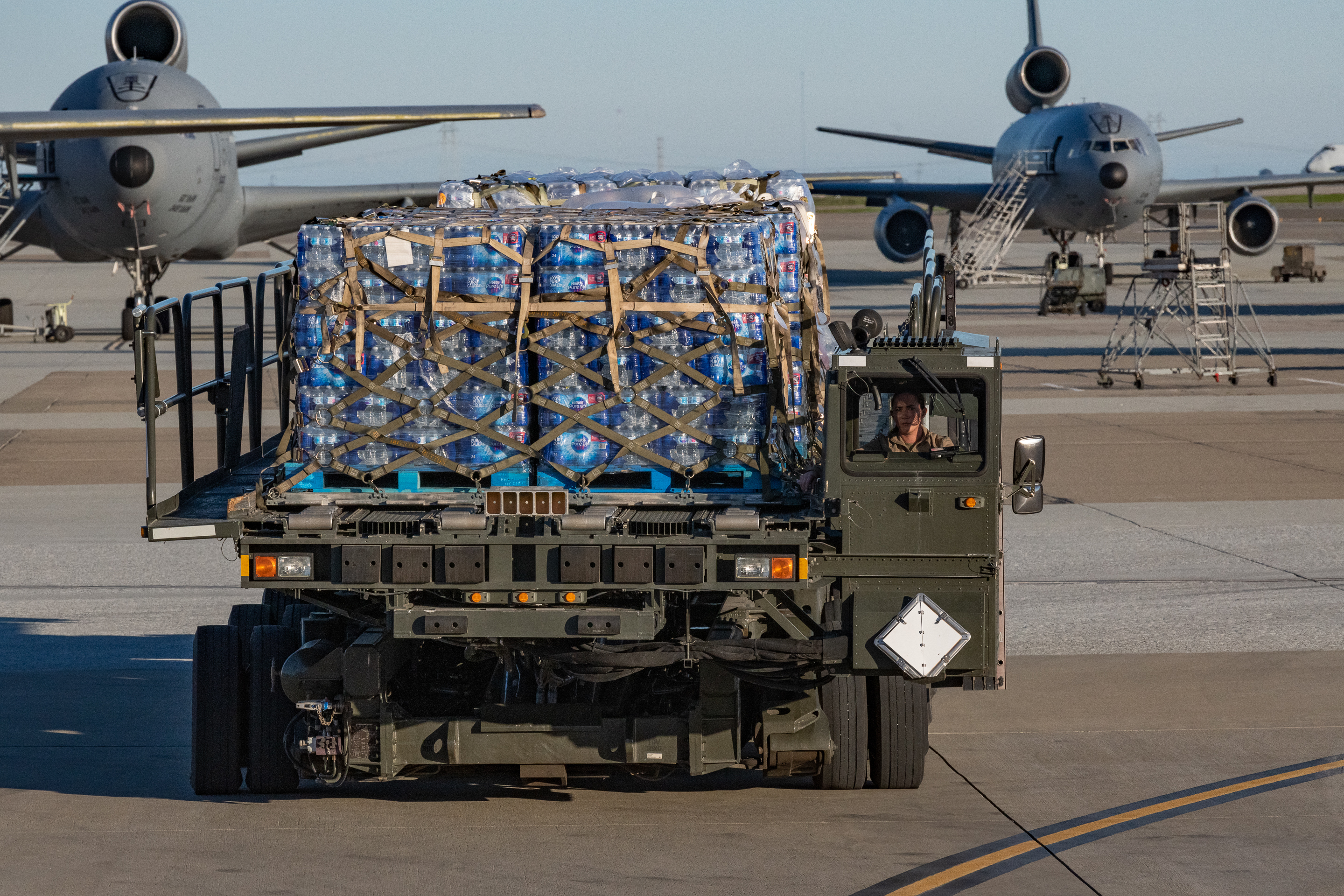 Air transportation specialists from the 60th Aerial Port Squadron at Travis Air Force Base, California assist in loading water and other supplies onto a U.S. Air Force C-17 Globemaster III from the 446th Airlift Wing, Dec. 10, 2021.

The Joint Base Lewis-McChord C-17 stopped at Travis, while en route to support the U.S. Transportation Command (USTRANSCOM) Red Hill Water Movement for Joint Base Pearl Harbor-Hickam, Hawaii, water quality restoration efforts. They delivered more than 52,000 half-liter bottles of water to help military members and their families. (U.S. Air Force photo by Grant Okubo)