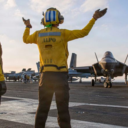 Navy sailors signal to an F-35C Lightning II on the flight deck of the USS Abraham Lincoln during operations in support of the war in Iran, on Tuesday, March 3, 2026.