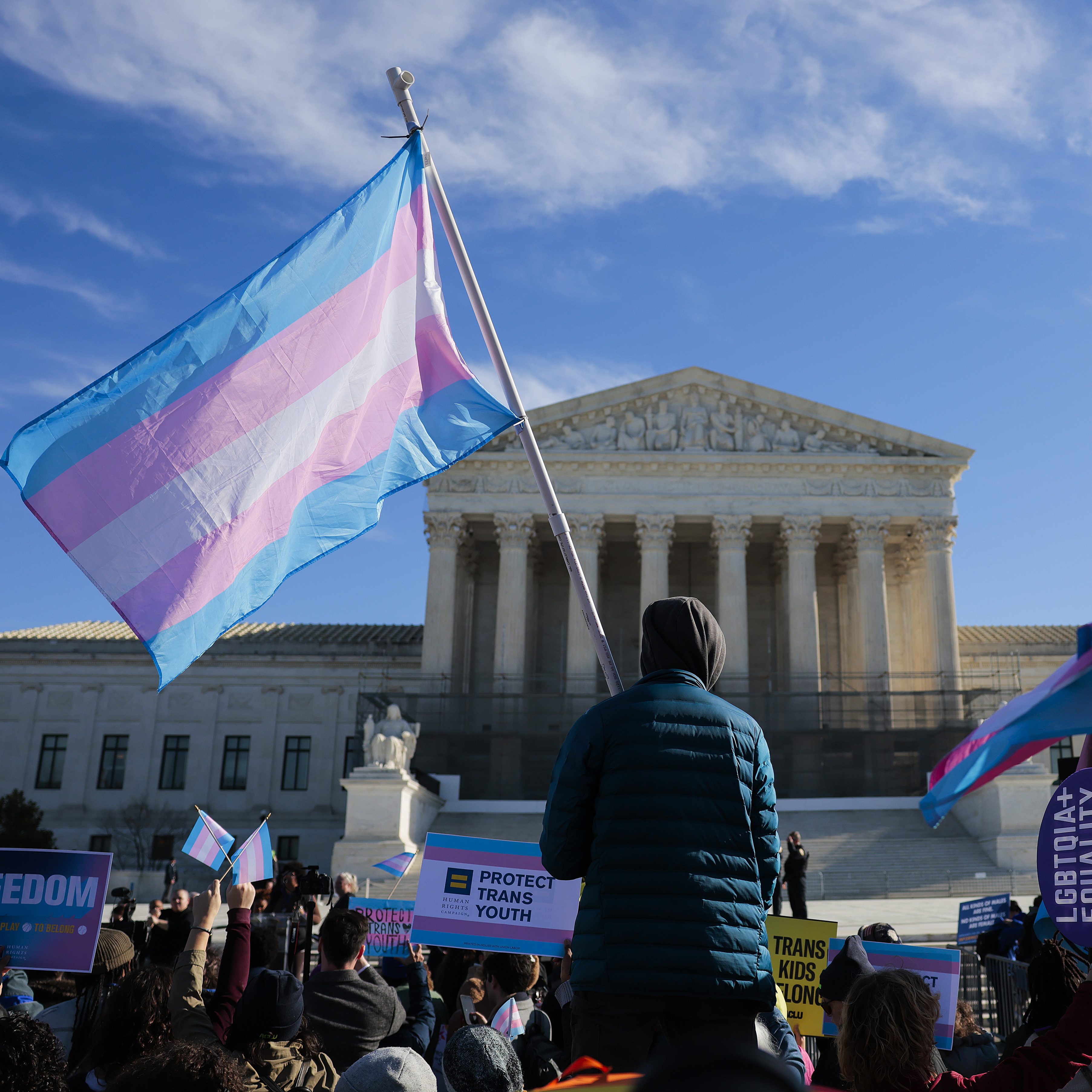 WASHINGTON, DC - JANUARY 13: Protesters supporting transgender athletes competing in women's sports gather outside the Supreme Court on January 13, 2026 in Washington, DC. Groups from both sides of the debate gathered on Tuesday morning to protest while two cases that prohibit transgender girls from joining girls' and women's sports teams are heard inside the Supreme Court. (Photo by Heather Diehl/Getty Images)