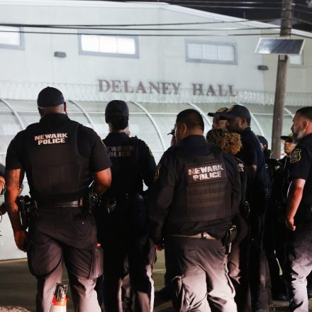 NEWARK, NEW JERSEY - JUNE 02: Newark Police officers stand guard as protesters gather outside the federal immigration center at Delaney Hall in Newark, where ICE is housing detained immigrants on June 02, 2026 in Newark, New Jersey. The city of Newark lifted a curfew Tuesday evening, allowing protesters to gather again in front of Delaney Hall. Despite the state police taking over security outside, the protests have become increasingly tense, and come amid reports of poor living conditions inside the facility for the detainees. (Photo by Spencer Platt/Getty Images)