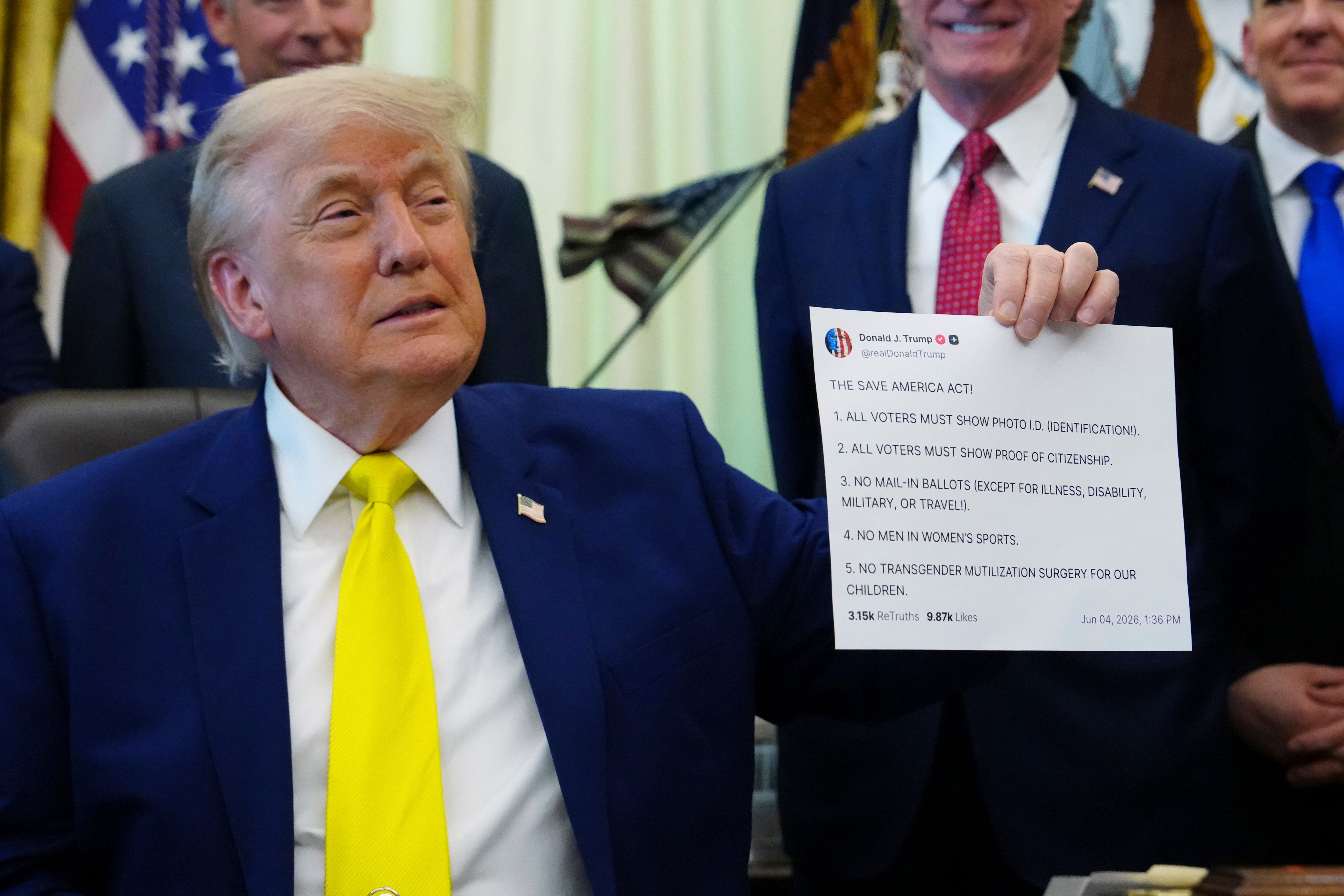 President Donald Trump holds up an image taken from his Truth Social account at an event about coal, Thursday, June 4, 2026, in the Oval Office of the White House in Washington. (AP Photo/Julia Demaree Nikhinson)