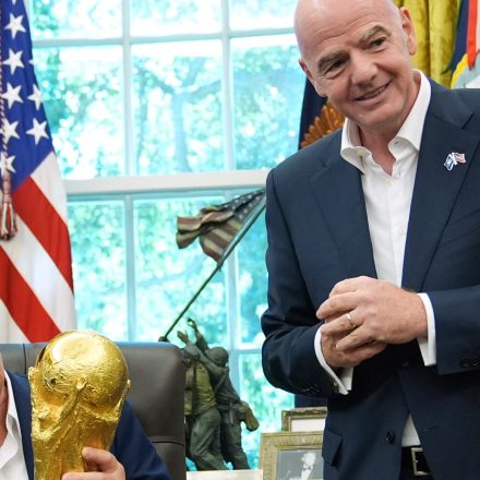 President Donald Trump holds the FIFA World Cup Winners Trophy as FIFA President Gianni Infantino looks on during an announcement in the Oval Office of the White House, Aug. 22, 2025, in Washington.