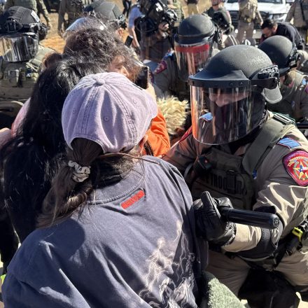 Protestors and law enforcement clash during a demonstration and vigil outside the South Texas Family Residential Center in Dilley, Texas, on January 28, 2026. Five-year-old Liam Conejo Ramos and his father, Adrian Conejo Arias, asylum seekers from Ecuador who were arrested on January 20 in Minneapolis by ICE agents, are being held at the center along with others detained by ICE. US President Donald Trump said on January 27 that he would "de-escalate a little bit" in Minneapolis after the fatal shootings of two civilians fueled a storm of criticism over his signature immigration crackdown. (Photo by Moisés ÁVILA / AFP via Getty Images)