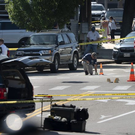 BIDDEFORD, ME - JULY 13: An FBI official places an evidence card on Pool Street in Biddeford where a man was reportedly killed in a shooting involving U.S. Immigration and Customs Enforcement agents on Monday, July 13, 2026. MANDATORY CREDIT: (Gregory Rec/Portland Press Herald)