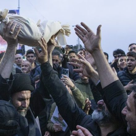 A cleric raises the body of Mohammad Ali Kialha in a funeral procession in Qazvin, Iran on March 23.
