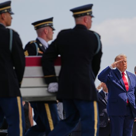 President Donald Trump and Secretary of Defense Pete Hegseth, salute as a U.S. Army carry team moves a transfer case containing the remains of Pvt. Isabella Gonzales of Carrollton, Texas, Wednesday, July 22, 2026, at Dover Air Force Base, Del.