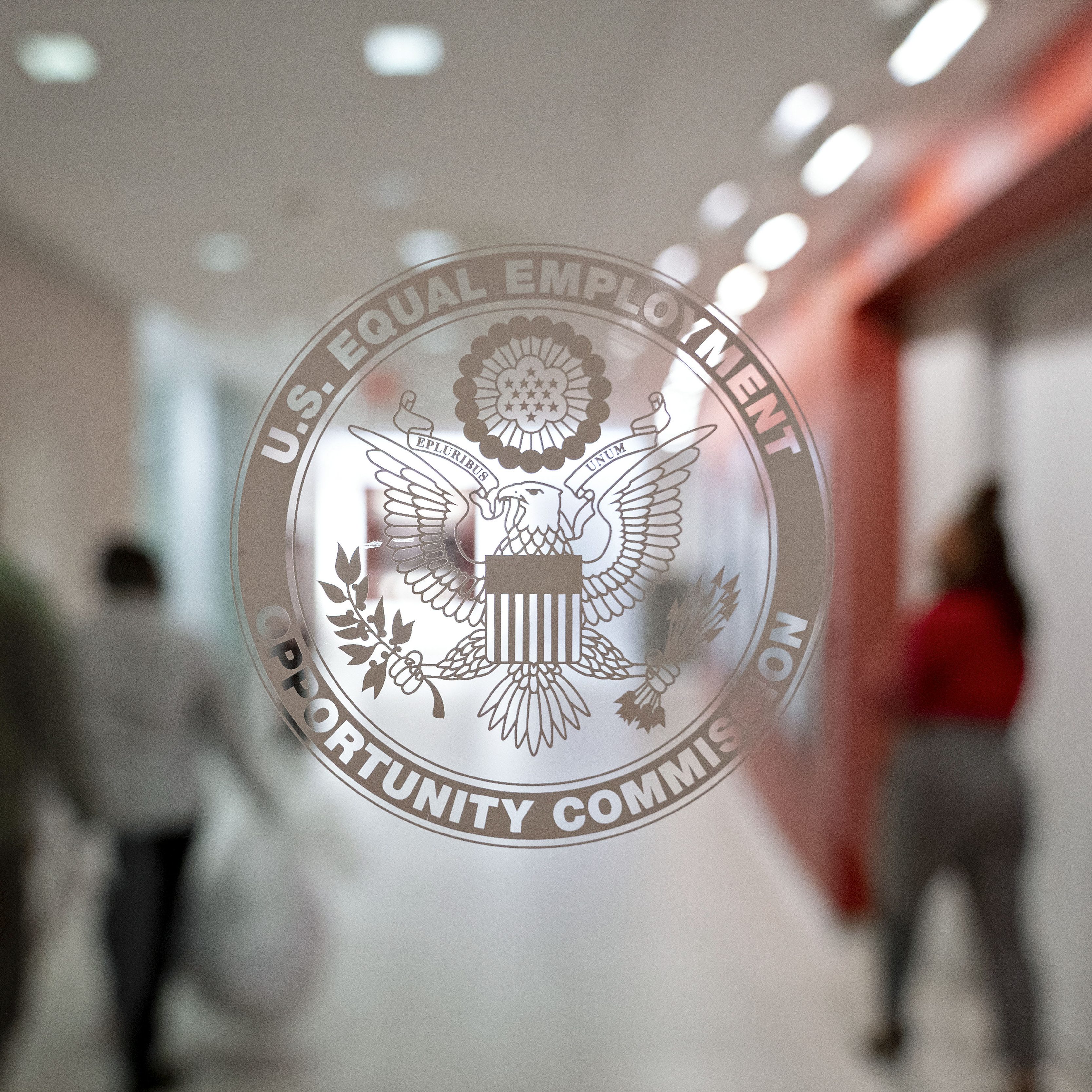 The Equal Employment Opportunity Commission (EEOC) seal is displayed on a window at the headquarters in Washington, D.C., U.S., on Tuesday, Feb. 18, 2020. The Trump administration wants to cut fiscal year 2021 spending on the Labor Department, National Labor Relations Board, and EEOC, reviving previous belt-tightening bids that have not been approved by Congress. Photographer: Andrew Harrer/Bloomberg via Getty Images