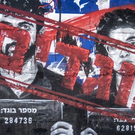 A graffiti mural depicting Israeli filmmakers Yuval Abraham and Rachel Szor, directors of the documentary 'NAZA'- which documents civilian deaths in Gaza, features testimonies from Israeli military personnel involved in targeting and remote killing mechanisms, and frame military operations as genocide - is altered in Ashdod, Israel, on September 16, 2026. Initially painted by an artist accusing the filmmakers of being 'traitors,' the text on the mural was subsequently modified by another artist to read 'heroes.'