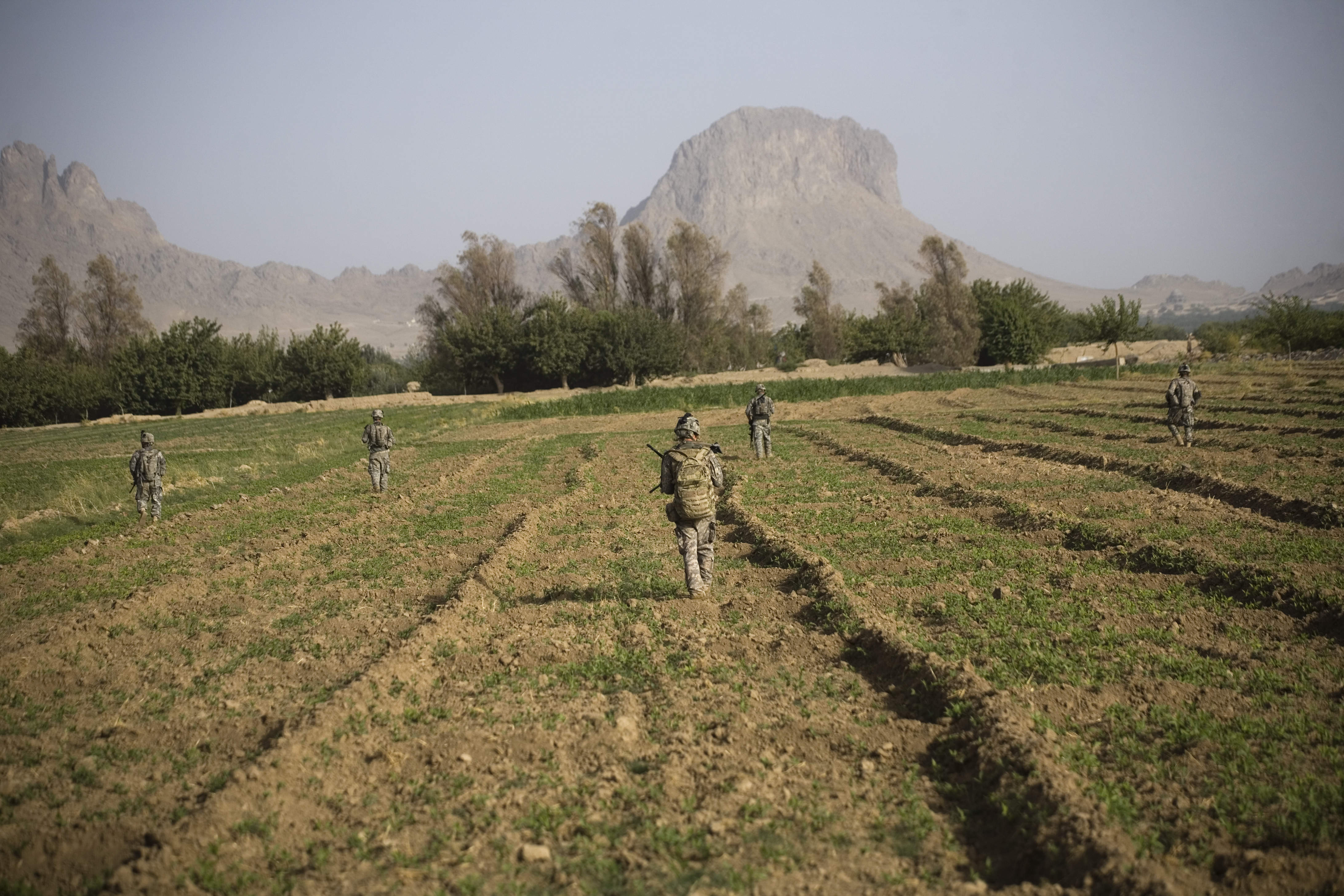 US soldiers from the 1-320th Alpha Battery, 2nd Brigade of the 101st Airborne Division, patrol near COP Nolen, in the volatile Arghandab Valley, Kandahar, Afghanistan, Monday, July 26, 2010. (AP Photo/Rodrigo Abd)