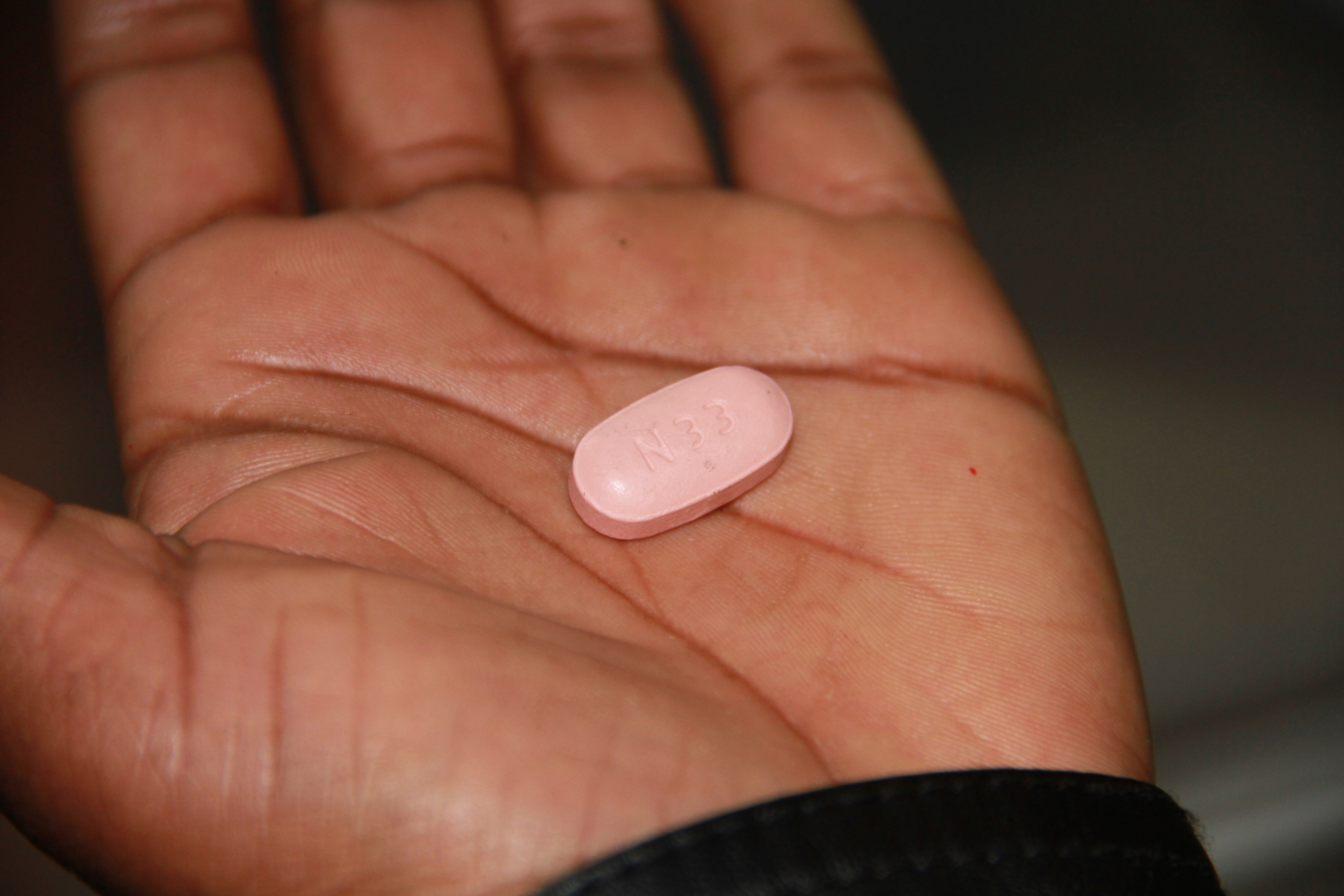 A 36-year-old HIV-positive sex worker and mother of one who requested anonymity, shows a antiretroviral drug bought illegally on the blackmarket in Johannesburg, South Africa, Friday, June 20, 2025. (AP Photo/Louise Dewast)